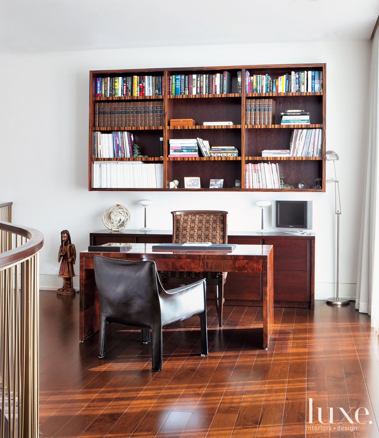Office space with brown furniture Luxe Interiors + Design