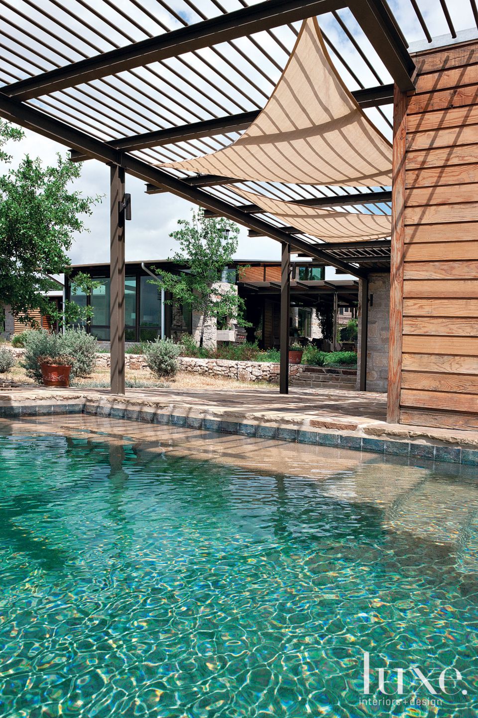 Modern Poolside Deck with Metal Overhang Luxe Interiors + Design