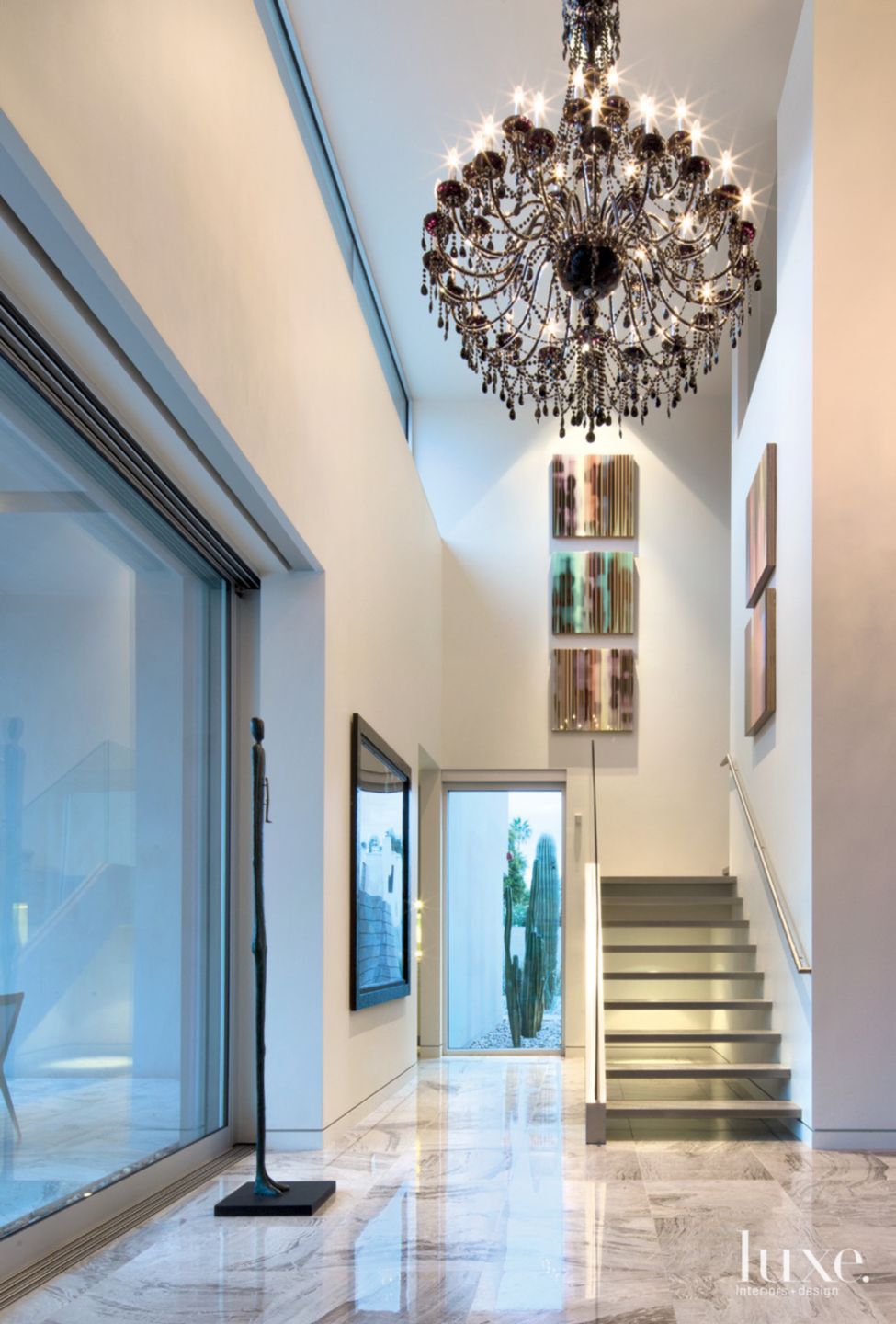 Modern White Hall with Crystal Chandelier - Luxe Interiors + Design
