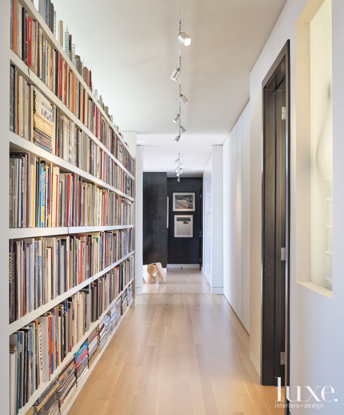 Modern White Hall with Built-In Bookshelves - Luxe Interiors + Design
