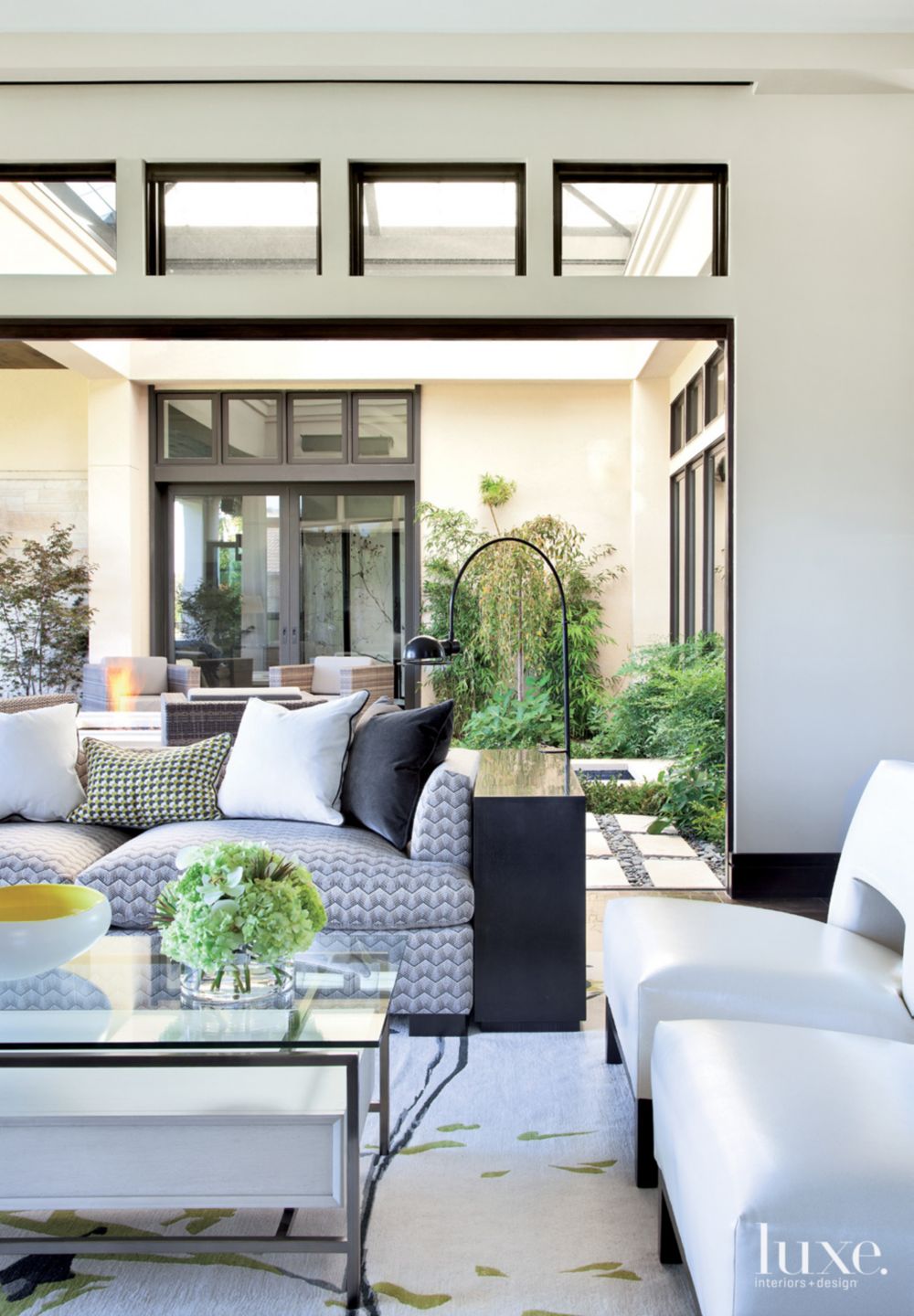 Contemporary White Living Room with Folding Doors - Luxe Interiors + Design