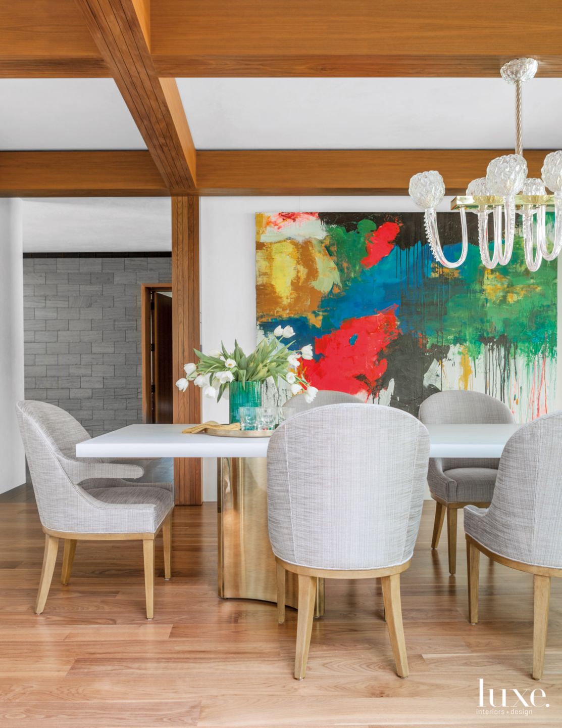 Modern Neutral Dining Room with Dramatic Artwork - Luxe Interiors + Design