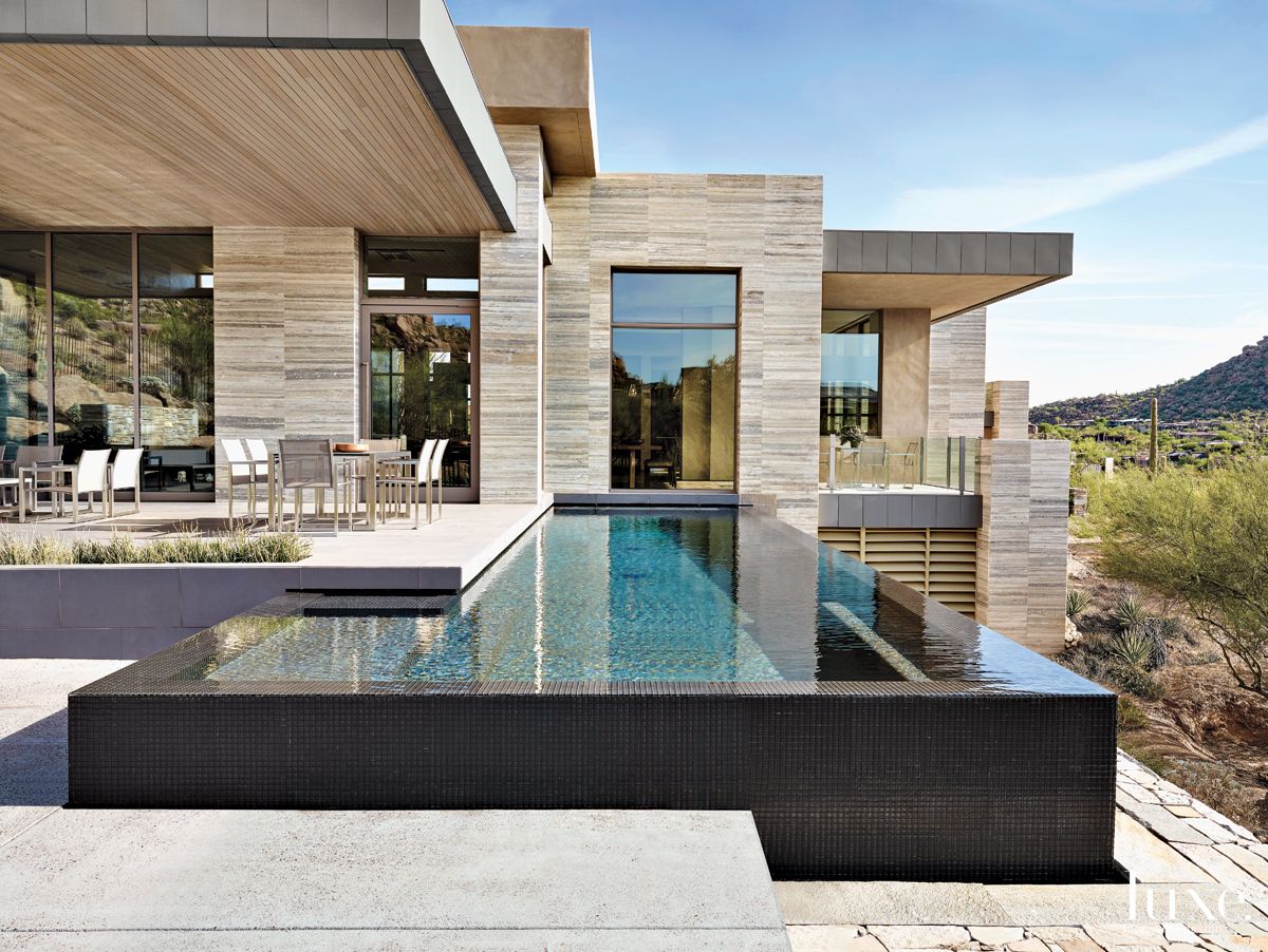 Modern Neutral Pool Area with Infinity Lap Pool - Luxe Interiors + Design