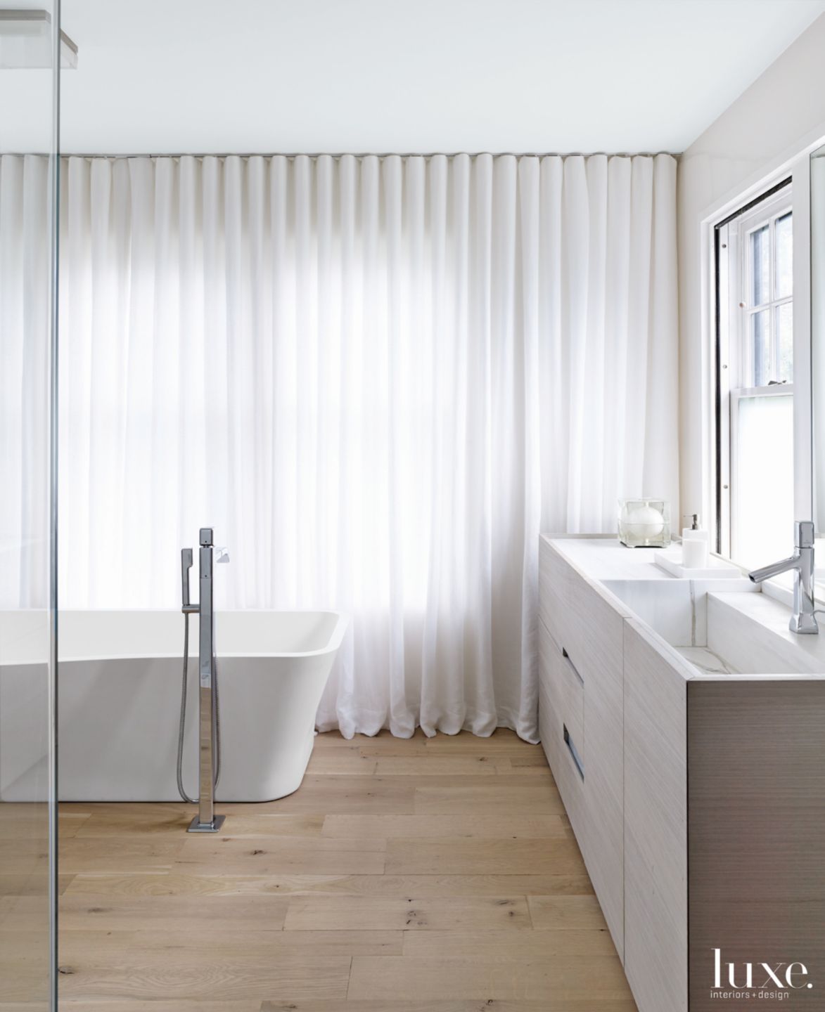 Modern White Bathroom with Oak Flooring - Luxe Interiors + Design