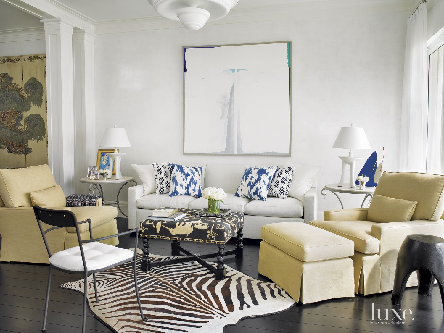 Eclectic White Family Room with a Zebra Rug - Luxe Interiors + Design